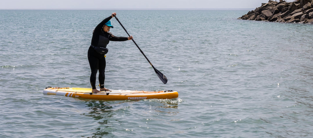 Woman paddling on a Thurso Surf inflatable stand up paddleboard